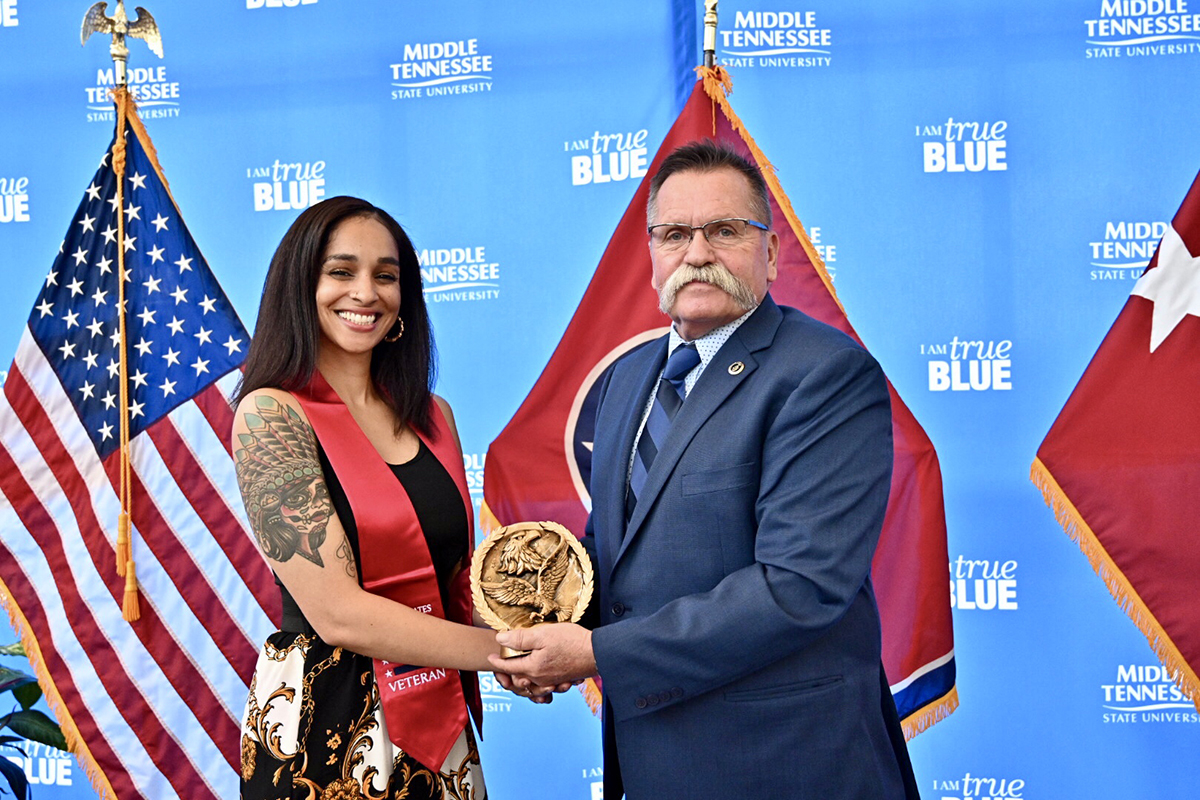Misty Francis, left, an MTSU graduating veteran, was presented the Journey Award from David Corlew with the Charlie Daniels-led Journey Home Project foundation Wednesday, April 24, at the Miller Education Center. Nearly 50 graduating senior student veterans were given their red stoles to wear during graduation May 3-4.