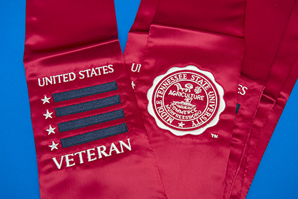Made by Jostens, the red stole, with both veteran and MTSU logos, is awarded to graduating student-veterans.