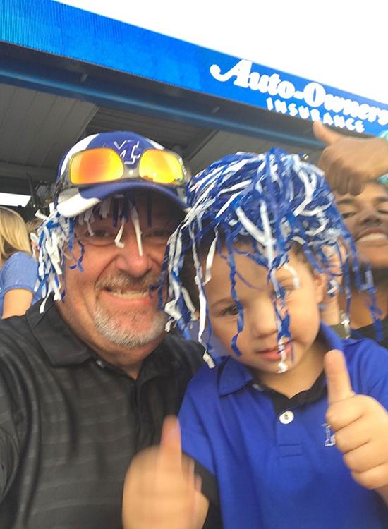 In this undated photo, MTSU alumnus and EMT Scott Storey (Class of 2017) of Mt. Pleasant, Tenn., left, and his youngest son, Ben, enjoy a Blue Raider football game at Floyd Stadium. Storey, now 53, earned his bachelor’s degree in professional studies through MTSU Online, a move that he said "pole-vaulted" his career. (Submitted photo)