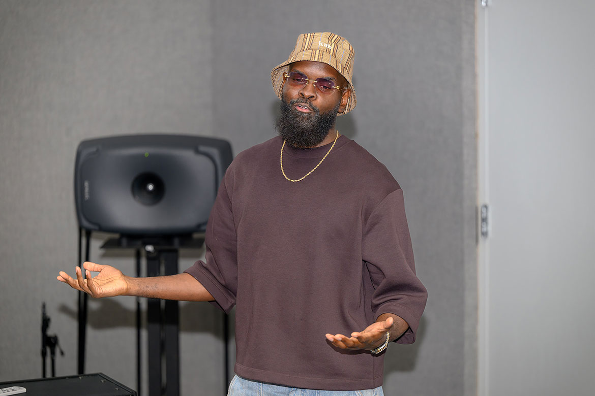 Torrance "Street Symphony" Esmond, a 2003 alum from Middle Tennessee State University’s College of Media and Entertainment and an adjunct professor, speaks to a group of Seattle, Wash., teenagers participating in Cliff’s Crew’s annual summer trip, which included a July 30, 2025, trip to MTSU’s audio production lab on campus in Murfreesboro, Tenn.  (MTSU photo by James Cessna)