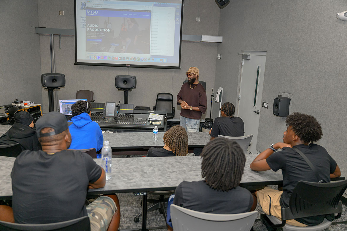 Torrance "Street Symphony" Esmond, a 2003 alum from Middle Tennessee State University’s College of Media and Entertainment and an adjunct professor, speaks to a group of Seattle, Wash., teenagers participating in Cliff’s Crew’s annual summer trip, which included a July 30, 2025, trip to MTSU’s audio production lab on campus in Murfreesboro, Tenn. Cliff’s Crew is part of retired NFL and Super Bowl champion Cliff Avril’s nonprofit organization, the Cliff Avril Family Foundation, that focuses on college and career exploration, cultural heritage and Black excellence in leadership. (MTSU photo by James Cessna)