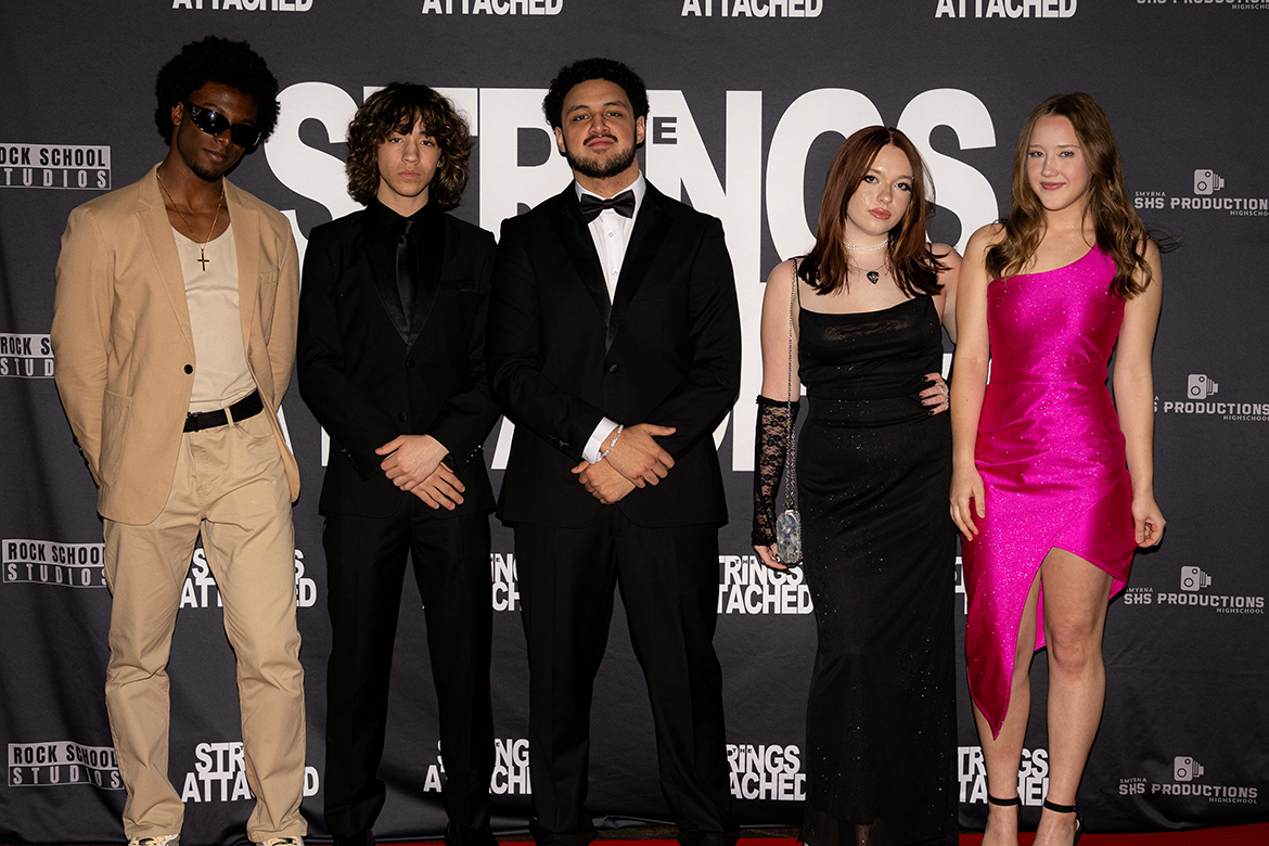 “The Strings Attached,” a film created and produced by Smyrna High School students under the supervision of teacher Kyle Dietz, premiered at the Malco Theaters in Smyrna, Tenn., on April 25, 2024. Students involved in the project walked the red carpet before the film’s premiere on the big screen. Pictured, from left, are actors Marquise Martin and Gavin Averhoff, student director Alan Mata, and student actresses Ciara Robinson and Marcail Dlouhy. (Photo courtesy of Kyle Dietz)