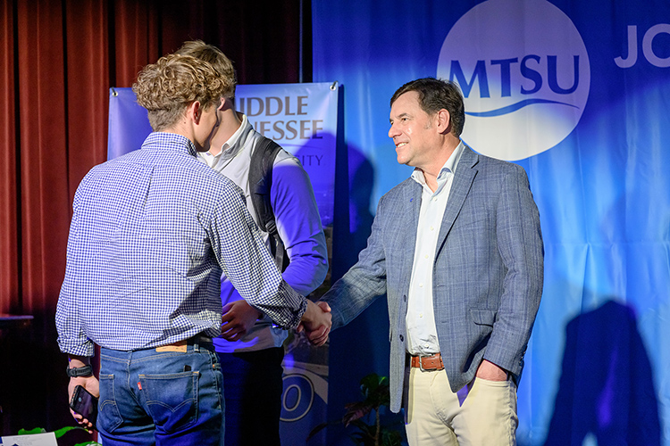 Mike Honious, president and CEO of transportation and logistics company Geodis Americas region, greets a student following his keynote remarks from the stage of the Keathley University Center Theater during the 2024 Midsouth Supply Chain Summit held April 11 at Middle Tennessee State University in Murfreesboro, Tenn. (MTSU photo by J. Intintoli)