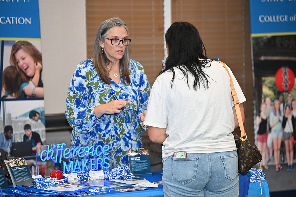 Tiffany Fantine, left, director of advising in the College of Education at Middle Tennessee State University in Murfreesboro, Tenn., speaks to an attendee during MTSU’s True Blue Tour student recruitment stop on Thursday, Sept. 18, at the Leslie Town Centre in Cookeville, Tenn. (MTSU photo by James Cessna)