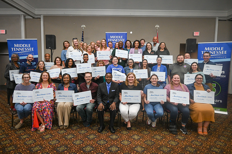 Middle Tennessee State University President Sidney A. McPhee, seated center front, takes a photo with Nashville-area high school and community college counselors and staff during the university’s True Blue Tour appreciation luncheon at the Millennium Maxwell House Hotel in Nashville, Tenn., on Oct. 3, 2023. Staffers each took a $2,500 scholarship back to their schools as part of MTSU’s newly launched High School and Community College Counselor Scholarships program. (MTSU photo by Stephanie Wagner)