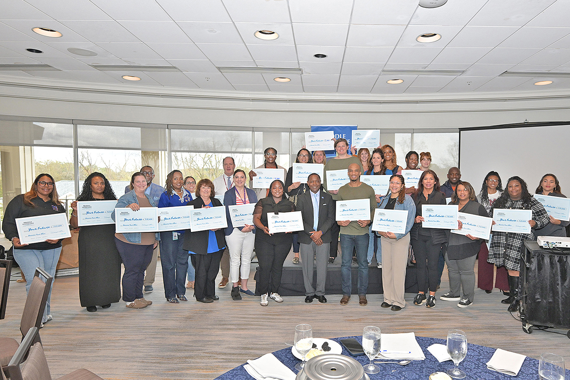 Middle Tennessee State University President Sidney A. McPhee, center, stands with representatives from nearly 30 area high schools and community colleges at the True Blue Tour counselors luncheon held Tuesday, Oct. 28, at Gaylord Springs Golf Links in Nashville, Tenn. McPhee gave out $2,500 scholarships to 27 institutions, with Antioch High School and Nashville State Community College each receiving $5,000 for sending the most Blue Raiders to campus for the 2025 academic year. (MTSU photo by James Cessna)