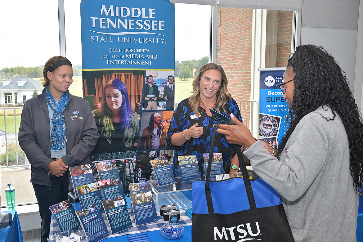 College of Behavioral and Health Sciences advisor Tanyika Carter, left, and Janell Fisher, director of advising for the Scott Borchetta College of Media and Entertainment at Middle Tennessee State University in Murfreesboro, Tenn., talk with a school counselor attending the True Blue Tour counselors luncheon held Tuesday, Oct. 28, at Gaylord Springs Golf Links in Nashville, Tenn. Nashville-area high school counselors and community college advisors were given information about MTSU to take back to their students, along with a total of $77,500 in scholarships to be given to potential Blue Raiders. (MTSU photo by James Cessna)