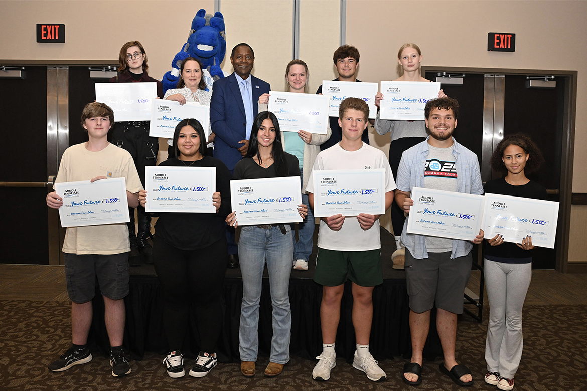 Middle Tennessee State University President Sidney A. McPhee, center, stands with students who were among the lucky winners in the scholarship drawings at the True Blue Tour recruitment stop for prospective students held Tuesday, Sept. 23, at the Farm Bureau Exposition Center. in Lebanon, Tenn. Twelve students won a total of $17,500 in scholarships. (MTSU photo by James Cessna)
