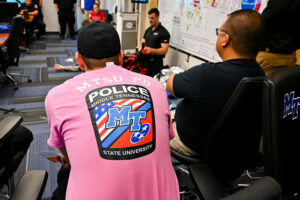 Lt. Andrew Bennett, left, and Sgt. Patrick Fajardo, right, both MTSU police officers, watch a Defend Systems demonstration on how to give tactical emergency casualty care on the MTSU campus on Sept. 17, 2020. (MTSU photo by Stephanie Barrette)