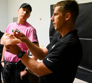 Lt. Andrew Bennett, left, watches as an instructor from Defend Systems demonstrates how to insert a nasopharyngeal airway during a tactical emergency casualty care training on the MTSU campus on Sept. 17, 2020. (MTSU photo by Stephanie Barrette)