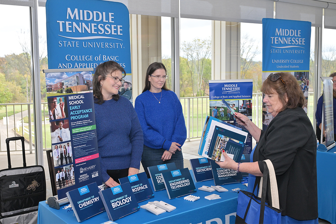 Susanna Beard, left, and Irina Novozhilova, middle, both academic advisors in the College of Basic and Applied Sciences at Middle Tennessee State University in Murfreesboro, Tenn., talk with a school counselor attending the True Blue Tour counselors luncheon held Tuesday, Oct. 28, at Gaylord Springs Golf Links in Nashville, Tenn. A total of $77,500 in scholarships was awarded to 29 Metro Nashville-area high schools and community colleges. Antioch High School and Nashville State Community College each were given $5,000 to dole out to students, with $2,500 scholarships going to the other 27 institutions. (MTSU photo by James Cessna)