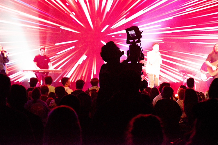 MTSU senior Johannes Litzenberger-Rivera, a video and film production major, checks video while capturing a Jan. 31 performance at "Unite 2020," a communitywide youth event held at Murfreesboro's New Vision Baptist Church. Department of Media Arts students and staff provided live video production support for the gathering as part of their training in multi-camera TV production. MTSU's move to online-only instruction this spring forced professors and students to find alternatives to their planned in-person, hands-on production opportunities when events were canceled. (Photo courtesy of MTSU senior photography major Madeline Quinby)