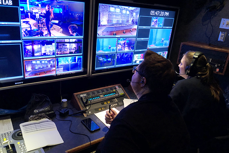 MTSU junior video and film production majors Ryan Tyler, left, and Molly Turner work in the university's $1.7 million Mobile Production Lab during an eight-camera, livestreamed concert in the round, "Run to the Father," Feb. 21 at The Experience Community Church in Murfreesboro, Tenn. The event, which included an in-house audience of more than 5,000 and an online audience of 12,000-plus, was one of 14 multi-camera shoots planned for the Department of Media Arts' spring 2020 Advanced Multi-Camera Video Production class. The COVID-19 pandemic, however, limited the class to only seven of its planned shoots before MTSU switched to remote instruction — and no off-campus experiential learning opportunities — for all its courses. (MTSU photo courtesy of Professor Robert Gordon)