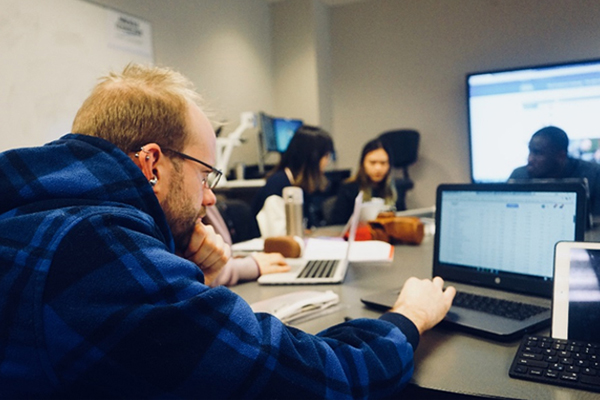In this Spring 2018 file photo, MTSU student Cody Bottoms does stock research inside a Business and Aerospace Building classroom as part of the TVA Investment Challenge class, an annual competition that allows college students from universities throughout the region an opportunity to manage a real stock portfolio to hone their analytical skills. The stock that Bottom’s student team recommended to invest, Adobe Inc., has gone up in value by more than 150% in two years. (Submitted photo)
