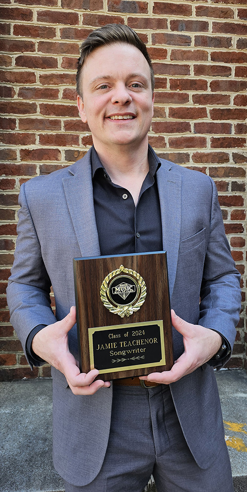 Missouri native Jamie Teachenor, an adjunct songwriting professor at Middle Tennessee State University, holds his Missouri Music Hall of Fame plaque outside the Paul W. Martin Sr. Honors Building on the MTSU campus in Murfreesboro, Tenn. (MTSU photo by Robin E. Lee)