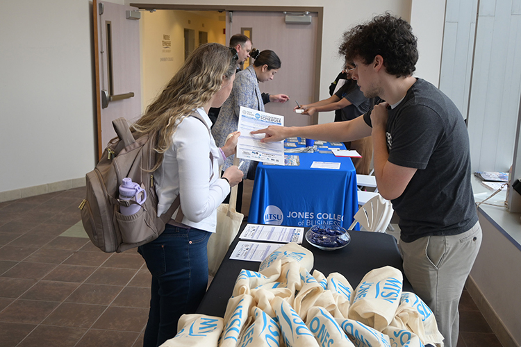 Attendees check in at the registration table for the 2025 Tech Vision Conference held April 10-11 in the Miller Education Center atrium on Bell Street on the MTSU campus in Murfreesboro, Tenn. (MTSU photo by Jimmy Hart)