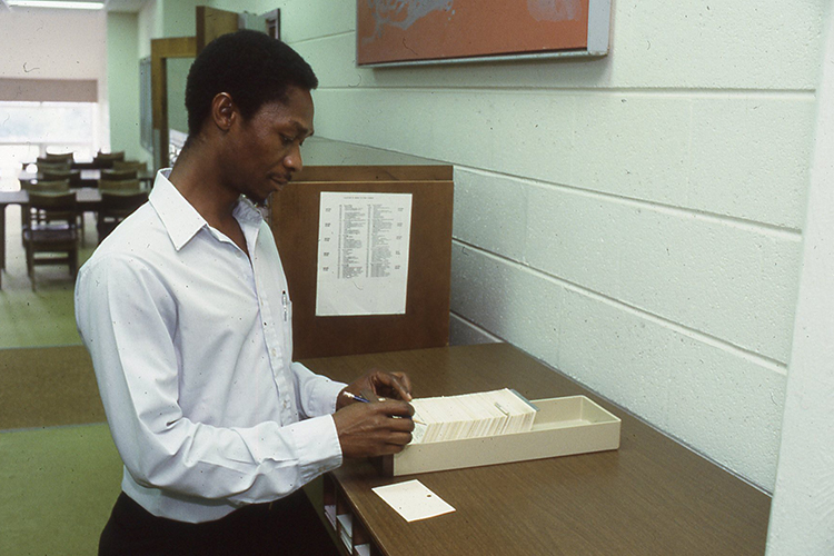 Momulu Massaquoi uses the card catalog in the Todd Library in this August 1990 file photo. (Photo submitted)