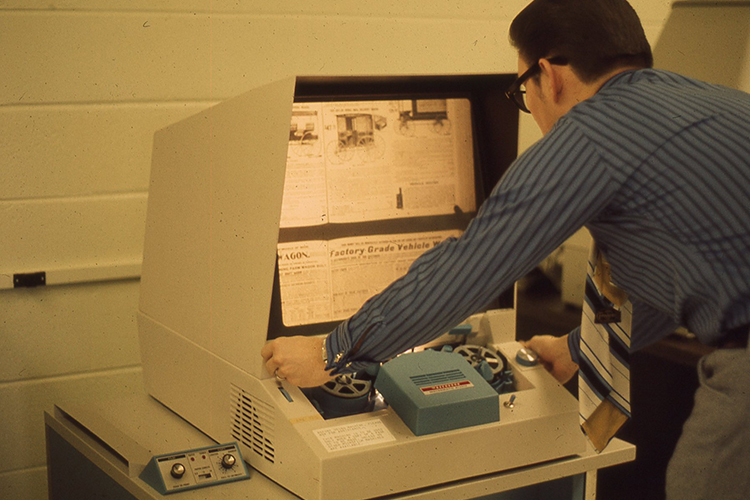 Library Dean Don Craig uses the microfilm reader in the Todd Library in this file photo from the 1980s. (Photo submitted)
