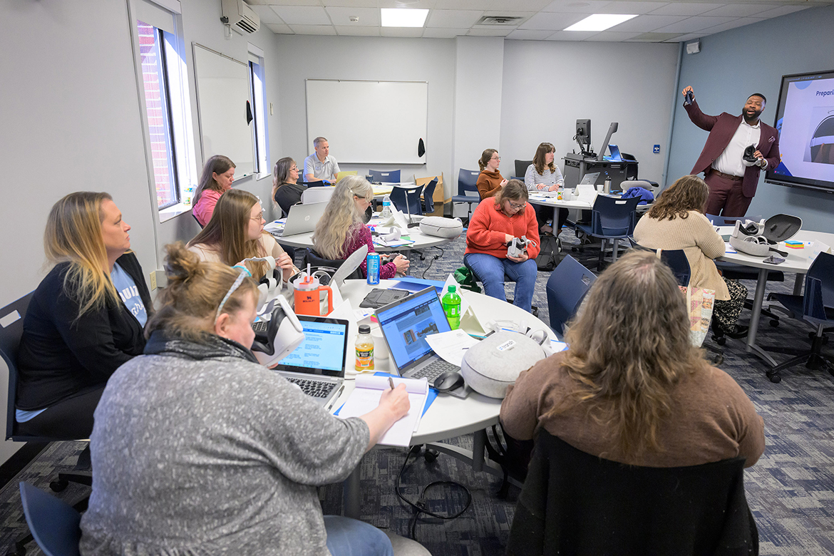 EJ Presley, far right, with virtual reality company Transfr, utilizes the VR technology to show attendees from Midstate rural libraries how to use the technology at a recent training workshop at Middle Tennessee State University in Murfreesboro, Tenn. Through a three-year, nearly $550,000 federal grant from the Institute of Museum and Library Services and managed by MTSU, six rural Tennessee libraries will utilize virtual reality training to help their community residents explore employment opportunities. (MTSU photo by Andy Heidt)