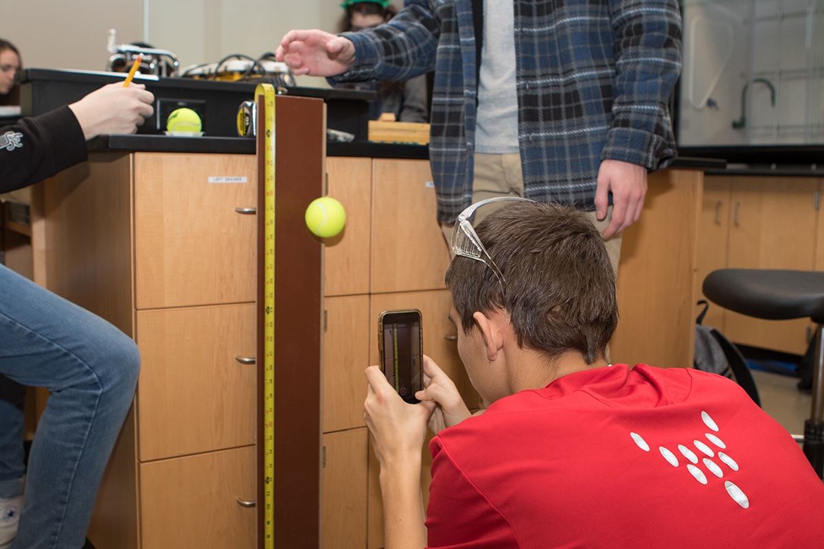 Trevor Smith of Page High School in Franklin, Tenn., uses his cell phone to take a photo of the project he and his teammates worked to record data for the “Experimental Design” event at the 24th annual Regional Science Olympiad at MTSU Feb. 23. (MTSU photo by James Cessna)
