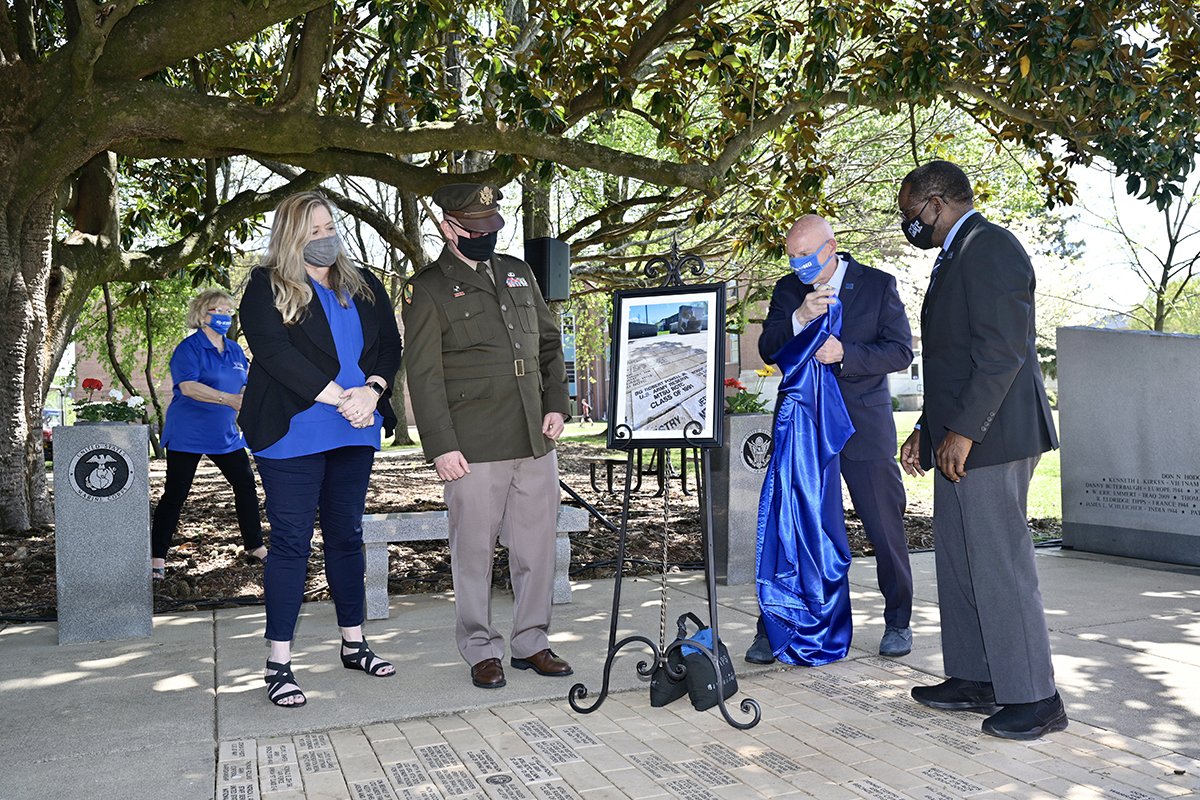Brig. Gen. Robert S. Powell Jr., an MTSU alumnus, and his wife and fellow alum, Jill, watch as Keith M. Huber, senior adviser for veterans and leadership initiatives, and MTSU President Sidney A. McPhee unveil a framed photograph of the commemorative brick that was placed at the MTSU Veterans Memorial site outside the Tom H. Jackson Building Monday, April 12. Powell is the 17th MTSU alumnus to become a general officer. The deputy commanding general of the 335th Signal Command in East Point, Georgia, is a 1991 graduate from the university and its ROTC program. (MTSU photo by Andy Heidt)