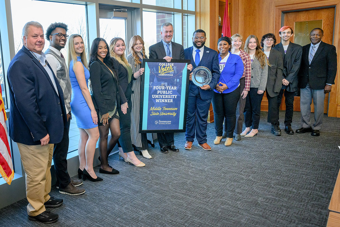 Secretary of State Tre Hargett presented Middle Tennessee State University with an award for winning the annual Tennessee College Voter Registration Competition in the four-year public school category at a luncheon on campus Nov. 28, 2023. Standing, from left, are Rutherford County Administrator of Elections Alan Farley; Delquan Dorsey, Student Government Association events director; Kelsey Ladd, SGA assistant events director; Zoe Spikner, SGA communications director; Riley Jacoby, SGA chief of staff; Caroline Spann, SGA election commissioner; Tennessee Secretary of State Tre Hargett; Michai Mosby, SGA president; Kalea Jackson, MTSU American Democracy Project vice president; Nancy Prescott, ADP graduate research assistant; Victoria Grigsby, ADP president; Dante Buttrey, ADP treasurer; Marcus Rosario, ADP member; and MTSU President Sidney A. McPhee. (MTSU photo by J. Intintoli)