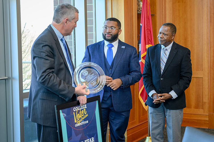 Secretary of State Tre Hargett presented Middle Tennessee State University with an award for winning the annual Tennessee College Voter Registration Competition in the four-year public school category at a luncheon on campus Nov. 28, 2023. Standing, from left, are Rutherford County Administrator of Elections Alan Farley; Delquan Dorsey, Student Government Association events director; Kelsey Ladd, SGA assistant events director; Zoe Spikner, SGA communications director; Riley Jacoby, SGA chief of staff; Caroline Spann, SGA election commissioner; Tennessee Secretary of State Tre Hargett; Michai Mosby, SGA president; Kalea Jackson, MTSU American Democracy Project vice president; Nancy Prescott, ADP graduate research assistant; Victoria Grigsby, ADP president; Dante Buttrey, ADP treasurer; Marcus Rosario, ADP member; and MTSU President Sidney A. McPhee. (MTSU photo by J. Intintoli)