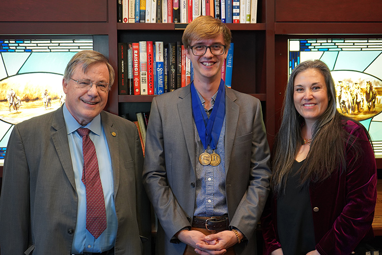 Pictured, from left, are Middle Tennessee State University Honors College Dean John Vile, Honors student Eli Ward, and Rebekka King, Ward’s thesis director and professor of religious studies. Ward, a religious students and nursing double major, successfully defended his Honors thesis titled “Communicated Commemorabilia: A Creative Project Exploring Christian Recovery” in early November. (Photo by Connie Bartemus)