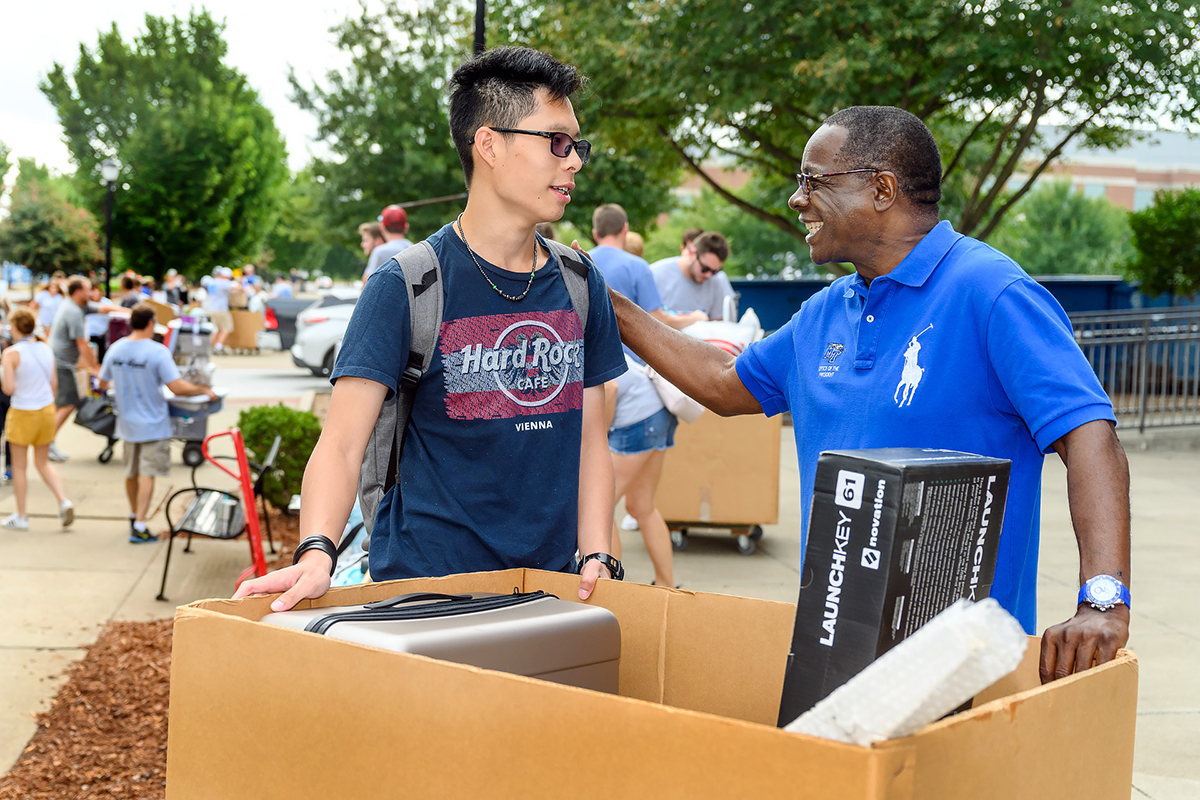 Leo Sun, left, an MTSU freshman form Hsinchu, Taiwan, is greeted by MTSU President Sidney A. McPhee Friday, Aug. 23, on the first of two days of We-Haul, a volunteer effort to help new students move into campus housing. Sun, who is an audio production major, was helped on the move-in by his mother, Sophia Chung, who also met McPhee. (MTSU photo by J. Intintoli)