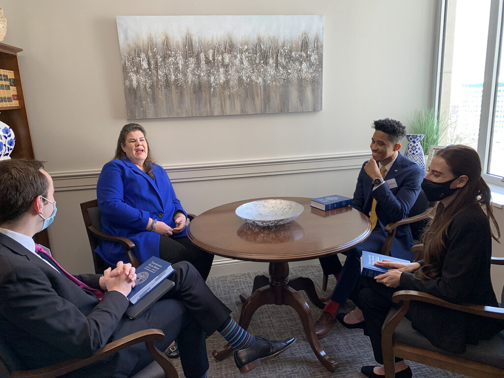 State Sen. Dawn White, second from left, of Murfreesboro, shares a laugh with MTSU student researchers Hunter Brady, left, DeVonte Lewis and Maria Clark Wednesday, Feb. 16, in her Cordell Hull office during the annual Posters at the Capitol. White had just given them copies of the 900-page Tennessee Blue Book for 2021-22. White represents District 13 (part of Rutherford County). (MTSU photo Randy Weiler)