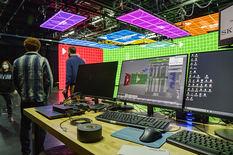 Multiple LED screens, controlled by the computers in the foreground, hang above and around the stage area in a Nashville studio in preparation for MTSU media students to begin production for a "teaser" commercial for the Department of Media Arts' new extended reality, or XR, stage, a new type of film and video production stage that will enable them to create projects anywhere, anytime. The MTSU XR facility, the only one of its kind at a Tennessee university, will be ready for classes this fall. (MTSU photo by Andy Heidt)