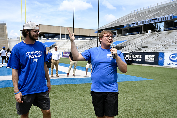 Blue Zoo Vice President Coby Marlow, right, and Zoo President Sawyer Roberts encourages students from the Office of Student Success’s Scholars Academy and STAR early arrival programs to be involved in the student athletics booster organization. The students helped unfurl the Blue Zoo banner for the first time this academic year from the student section inside Floyd Stadium Wednesday, Aug. 17. (MTSU photo by J. Intintoli)