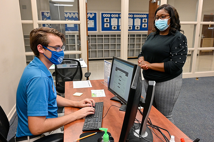 Ikeia Gaines, right, recent Middle Tennessee State University master’s graduate, gets help from Jason Wasilewski, MTSU peer career ambassador, at the university’s Career Development Center on Sept. 8, 2021. The center helped Gaines obtain her full-time probation officer position in Marshall County, Tennessee. (MTSU photo by Stephanie Barrette)