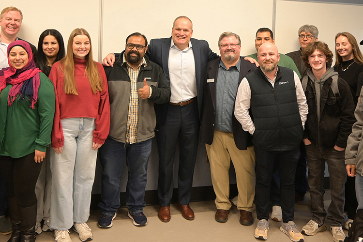 Retired FBI supervisory special agent Scott Augenbaum, center, takes a group photo with members of Middle Tennessee State University’s Association of Information Systems student chapter as well as faculty from the Department of Information Systems and Analytics after speaking at the monthly meeting on Tuesday, Feb 25, inside the Business and Aerospace Building on campus in Murfreesboro, Tenn. (MTSU photo by Jordan Reining)