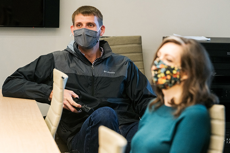 Blake Whitman, a Middle Tennessee State University assistant professor in concrete and construction management, shares a conversation with colleague Tiffany Rogers, an assistant professor of psychology, and others in a Science Building conference room on campus on March 31, 2021. (MTSU photo by Andy Heidt)