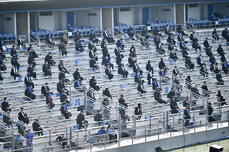 Graduating MTSU students sit, safely distanced and masked, on the east side of Floyd Stadium Saturday, Nov. 21, during the university's fall 2020 commencement ceremonies. MTSU, which held virtual graduations for its May and August graduates because of the pandemic, required strict health protocols for the graduates and limited their guests to help keep the three open-air events safer. (MTSU photo by J. Intintoli)