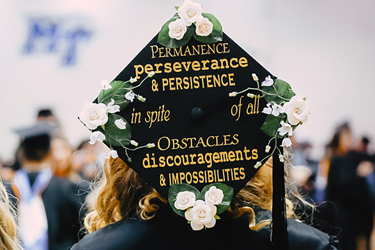 An MTSU Class of 2019 graduate proudly displays her customized mortarboard, complete with an inspirational quote from Scottish historian and essayist Thomas Carlyle, while preparing for the university's fall 2019 commencement ceremonies inside Murphy Center on Saturday, Dec. 14.(MTSU photo by GradImages)