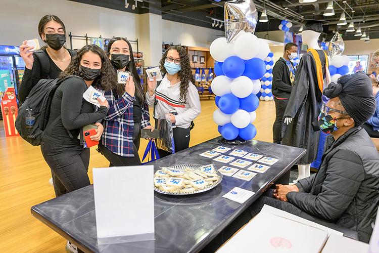 A group of MTSU graduating seniors show off tasty MTSU alumni-decorated cookies in Phillips Bookstore inside the Student Union Friday, Dec. 3, during the university's Senior Celebration. From left are physiology majors Sara Yosef and Martha Gatas, both of Antioch, Tenn.; Mariam Armanious of Mt. Juliet, Tenn., and Dena Fawzi of Nashville. They're being helped by junior psychology major Jordan Anderson, a bookstore employee. Students graduating Saturday, Dec. 11, in MTSU's fall 2021 commencement ceremonies were able to pick up regalia and learn about the university's Senior Gift Program for scholarships and other development needs, alumni services and career development. (MTSU photo by J. Intintoli)