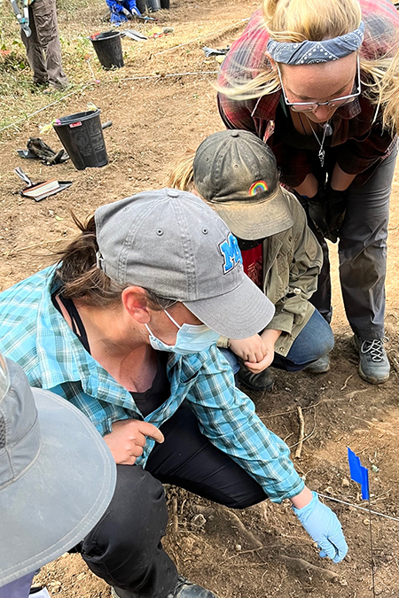 Tiffany Saul, left in mask, Middle Tennessee State University research assistant professor, guides MTSU students and a volunteer in forensic field procedures as part of MTSU’s Forensic Aviation Archaeology study abroad course where students helped search for remains of missing U.S. World War II personnel in August 2022 in France. (Photo courtesy of Tiffany Saul)