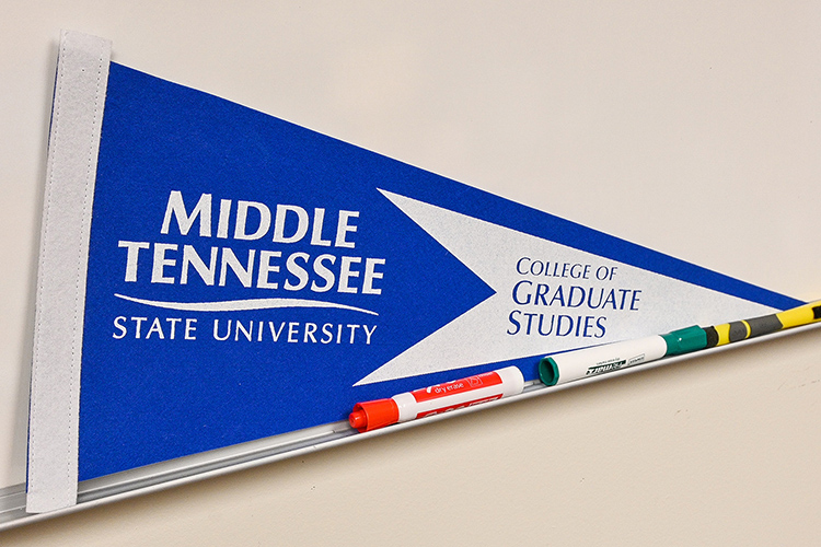 An MTSU College of Graduate Studies flag sits on the whiteboard in Sarah Hendrix’s office in the Sam Ingram Building on Oct. 15, 2020. (MTSU photo by Stephanie Barrette)