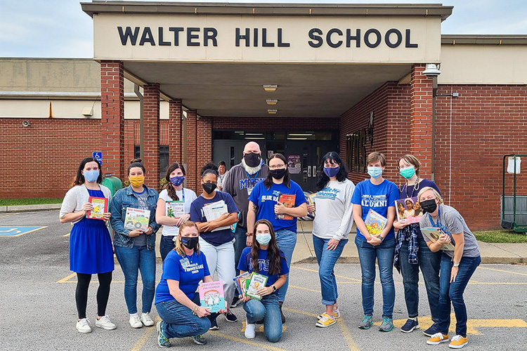 Several College of Education faculty are facilitating Literacy Night events that provide hands-on experience for students with local public-school children and the community. Pictured outside Walter Hill Elementary School at a recent event are, top row, from left, students Brooke Venkatraman, Ashley Purvis, Stacey Ells, Lauren Washington, Brian Myers, Tiffany Watt, Traci Hammiel, Sara Daily, Kristin Flowers, and Lauren Bracamontes. Bottom row, from left, are faculty member Bonnie Barksdale and student Emmy Lyles. (MTSU photo by Stephanie Barrette)