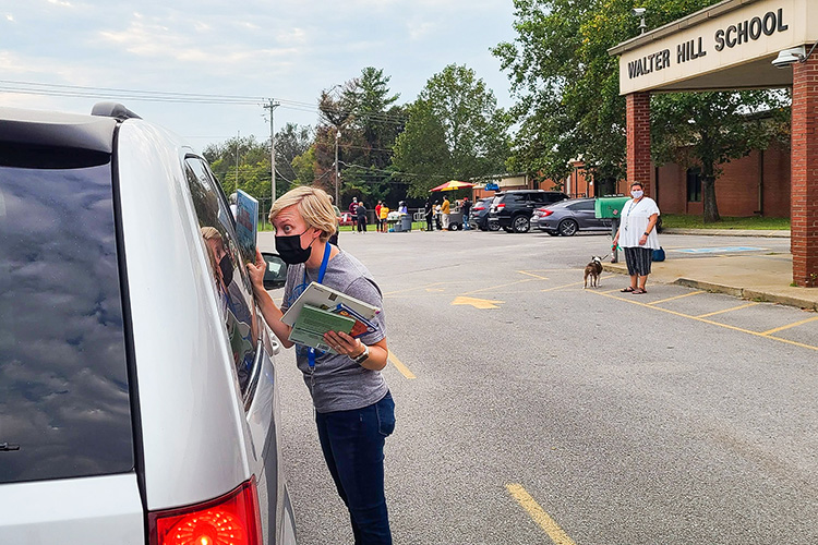 MTSU elementary and special education major Lauren Bracamontes serves a family during the most recent drive-thru Literacy Night event at Walter Hill Elementary School. In partnership with local school districts and local nonprofit Read to Succeed, Literacy Nights take place at local schools and bring together elementary school students, families and MTSU students for a complimentary meal and books provided by Read to Succeed. (MTSU photo by Stephanie Barrette)