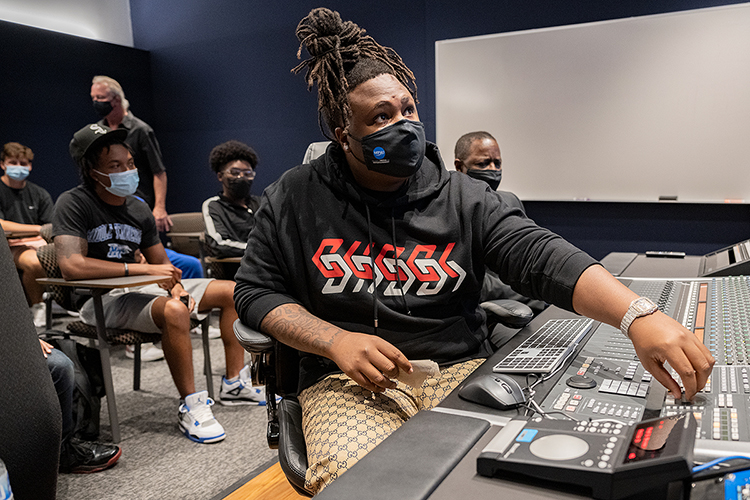 Memphis native and Grammy-nominated hip-hop producer BryTavious “Tay Keith” Chambers, 25, turns up the volume to one of his produced tracks Wednesday, Sept. 29, on the campus of his alma mater, Middle Tennessee State University, during a special “sneak-peek” visit to the MTSU Department of Recording Industry’s new studios on campus. Listening behind him are a group of MTSU students and university president Sidney A. McPhee. (MTSU photo by Cat Curtis Murphy)