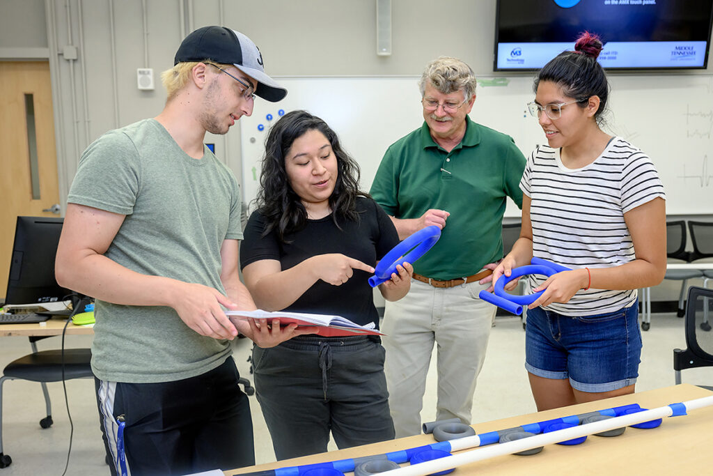 Middle Tennessee State University hosted undergraduate students from around the country who earned the National Science Foundation Research Experience for Undergraduates grant. Standing from left are Alex LaVerde, Carina Vazquez, William Robertson, MTSU physics and astronomy professor, and Jennifer Lopez who worked on math-based research like this acoustic ring resonance project on July 28, 2021, in the Wiser-Patten Science building. (MTSU photo by J. Intintoli)