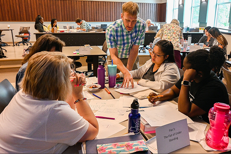Middle Tennessee State University math education professor Jeremy Winters, standing, instructs Murfreesboro City Schools teachers in math literacy training as part of Project Optimal in partnership with MCS on July 13, 2022, at the College of Education on campus. (MTSU photo by Stephanie Barrette)