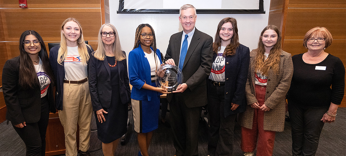 Tennessee Secretary of State Tre Hargett, center right, came to the Middle Tennessee State University campus on Thursday, Jan. 26, 2023, to present Student Government Association President Jada Powell, center left, with the award for the university winning his College Voter Registration Competition for the second time. Pictured with them, from left, the Student Union Parliamentary Room are students and members of the MTSU chapter of the American Democracy Project Elaf Alkazzaz, and Kayla Jenkins, professor and ADP coordinator Mary Evins, Powell, Hargett, ADP President and student Stevie Naumcheff, ADP member and student Victoria Grigsby and ADP board member and professor Laura Clark. (MTSU photo by Cat Curtis Murphy).