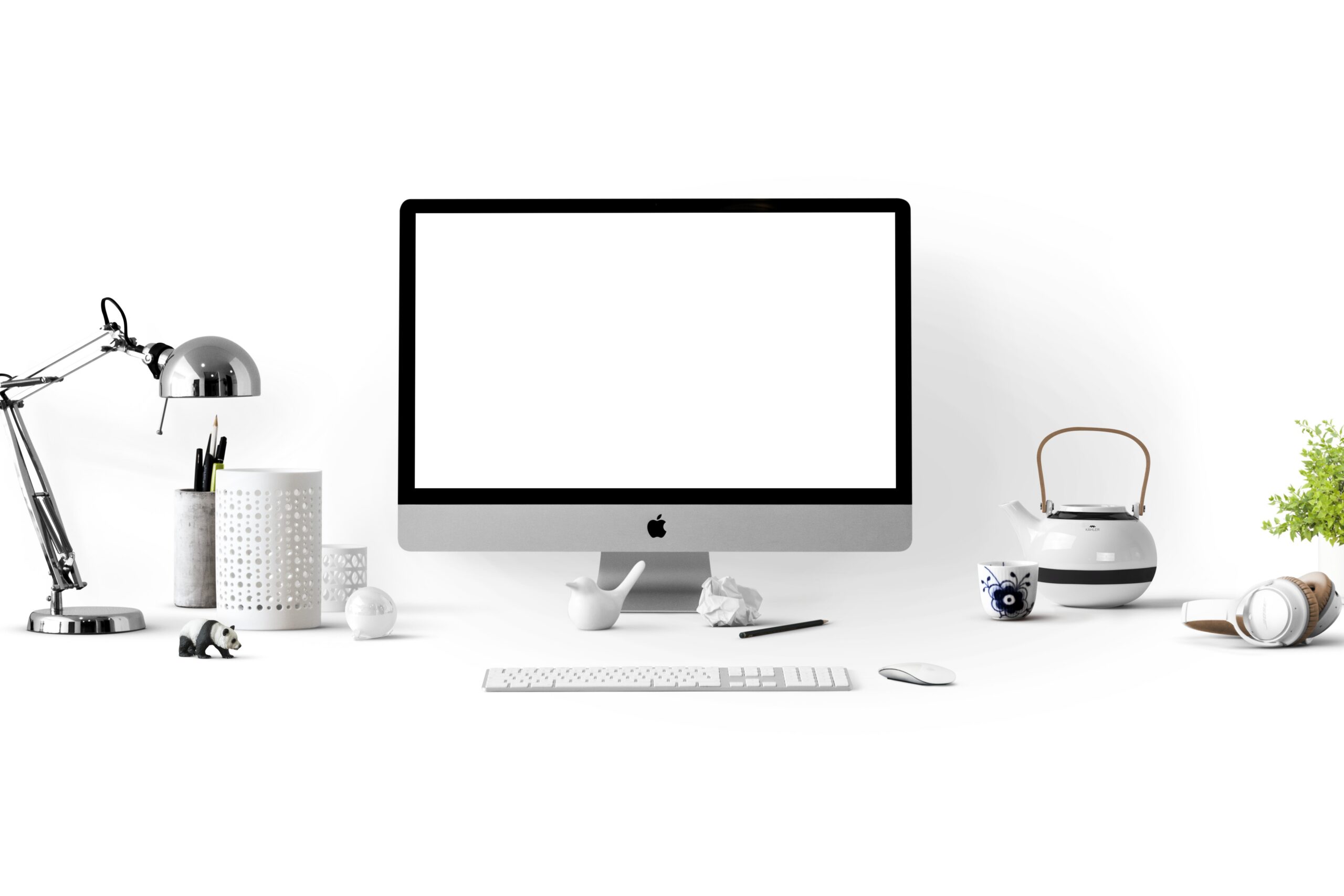 A computer and various desk accessories sit against a white background. 