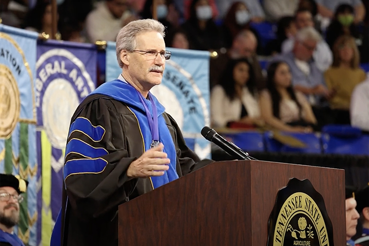 Middle Tennessee State University marketing professor Tim Graeff, recipient of the university’s 2021 Career Achievement Award and director of the MTSU Office of Consumer Research, speaks to graduates Saturday, May 7, during the university's spring 2022 evening commencement ceremony in Hale/Earle Arena inside Murphy Center. MTSU awarded 2,474 degrees — 2,041 to undergraduates and 433 to graduate students — during its three-ceremony spring 2022 commencement event. (MTSU photo by News and Media Relations)