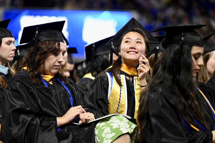 A Middle Tennessee State University graduate watches for her supporters in Hale/Earle Arena inside Murphy Center while waiting to receive her new degree Saturday, May 7, during the university's spring 2022 morning commencement ceremony. MTSU awarded 2,474 degrees — 2,041 to undergraduates and 433 to graduate students — during its three-ceremony spring 2022 commencement event. (MTSU photo by James Cessna)