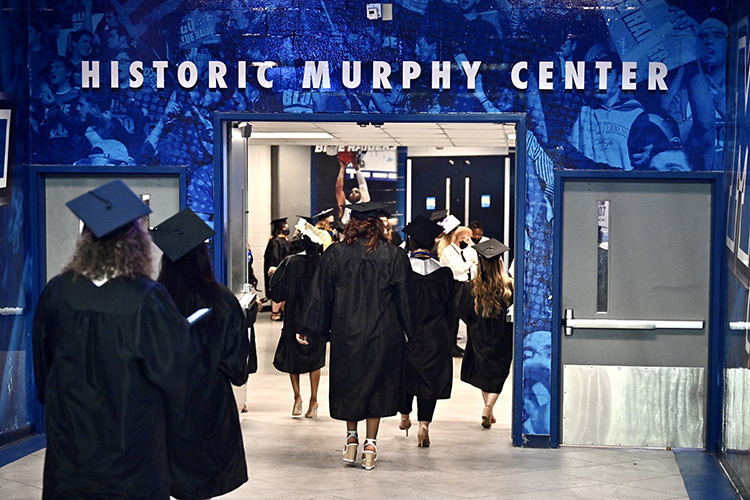 Members of MTSU's first Class of 2021 walk down a hallway under Murphy Center to take their seats in Hale Arena before one of the three spring 2021 commencement ceremonies held Friday, May 7, inside the facility. Graduates and their guests returned to Murphy Center May 7-9 for the first time since 2019 for a three-day, 10-event, socially distanced commencement weekend. (MTSU photo by J. Intintoli)